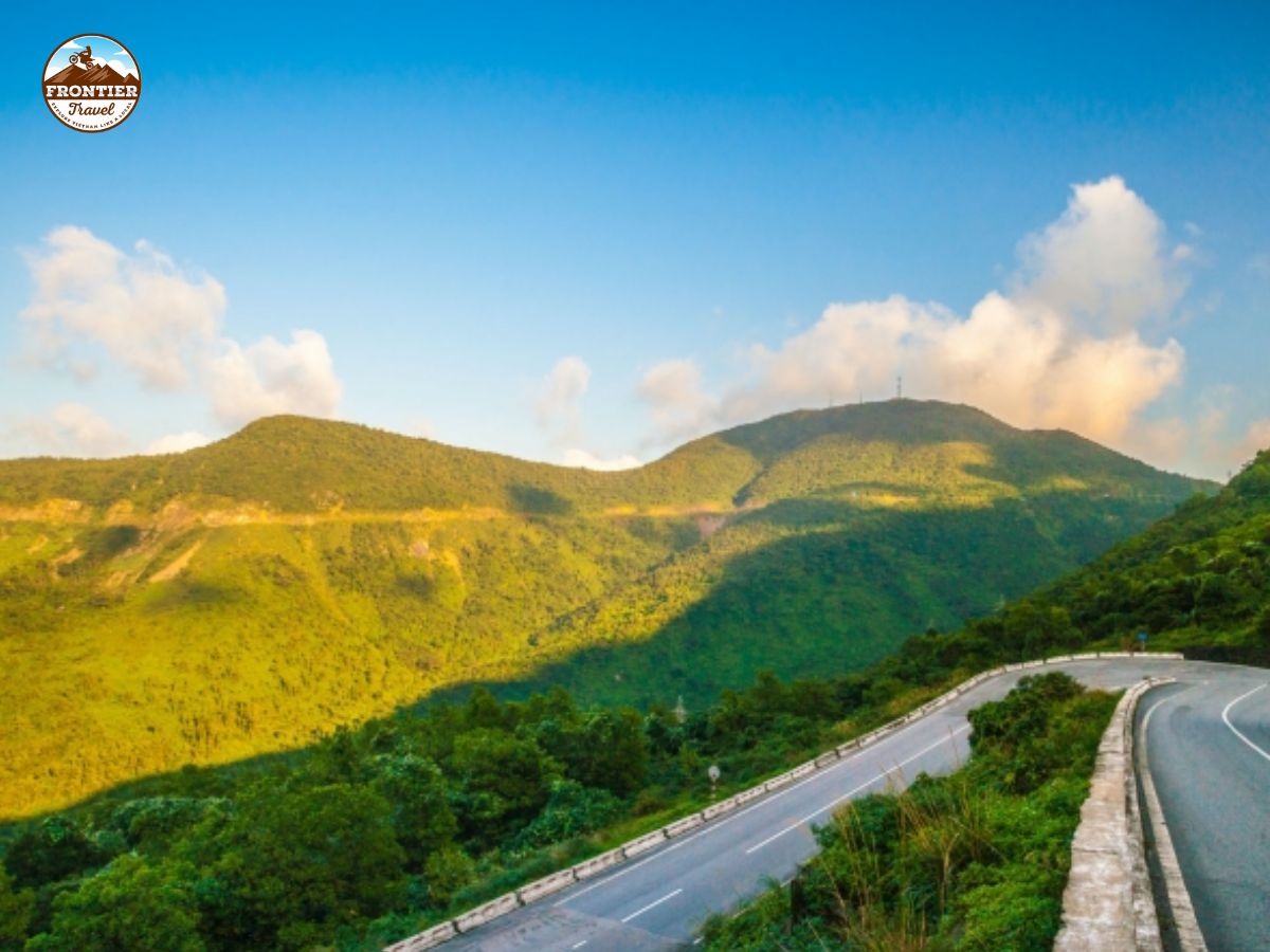  Hai Van Pass: Vietnam’s most iconic motorbike road  Hai Van Pass: Vietnam’s most iconic motorbike road 1. Hai Van Pass map: Location and overview 2. Why the Hai Van Pass Is a must-ride on your Vietnam motorbike tour 3. The best way to experience Vietnam’s legendary Hai Van Pass 4. Tips for riding the Hai Van Pass route safely  Hai Van Pass is Vietnam’s most iconic Da Nang to Hue motorbike route, famous for its winding curves and breathtaking scenery. Stretching along the coastline and through misty mountains, it offers riders unforgettable views at every turn. 1. Hai Van Pass map: Location and overview Hai Van Pass, also known as Ai Van Pass due to a historic gate at its summit, or Cloud Pass because its peak is often shrouded in clouds, stretches about 20 km and rises 500 meters above sea level.  Located on National Highway 1A, it marks the boundary between Thua Thien Hue Province (80 km away) and Da Nang City (20 km away).   Compared to many other passes in Vietnam, Hai Van is neither too long nor too treacherous, yet it stands out for its stunning scenery and dramatic curves, making it a must-visit for adventure seekers and nature lovers. 2. Why the Hai Van Pass Is a must-ride on your Vietnam motorbike tour Hai Van Pass is widely recognized as one of the 10 most beautiful coastal roads in the world and is considered the most stunning coastal mountain pass in Vietnam, making it one of the best motorbike roads in Vietnam.  Stretching approximately 20 km with an elevation of up to 500 meters above sea level, the Hai Van Pass route offers an exhilarating sense of adventure and conquest for every motorcyclist who rides it.  Along the route, sharp U-shaped bends make every motorcyclist's heart race, blending excitement with a hint of fear. But once these challenges are overcome, the reward is a magnificent natural landscape that makes all fatigue vanish. On one side, towering mountains stretch endlessly, while on the other, the vast, boundless sea unfolds, creating a rare natural panorama truly worthy of the title “The Most Majestic Pass Under Heaven.” From the summit, the expansive view allows travelers to admire the entire Lang Co Bay, Da Nang City, Cham Islands, Tien Sa Port, and Son Tra Peninsula. Every viewpoint is like a perfect painting, from the jade-green hues of the sea to the deep greens of the forest, harmoniously blending with the drifting clouds above. Hai Van Pass is not only famous for its challenging hairpin turns and steep slopes that test riding skills but also captivates visitors with its diverse natural scenery. The gently winding mountain slopes embrace the road, while tree canopies provide shade along the way, offering a sense of relaxation and closeness to nature. Meanwhile, the majestic East Sea, with its rhythmic waves and cool breeze at the summit, feels like a natural symphony soothing all the senses. 3. The best way to experience Vietnam’s legendary Hai Van Pass To truly appreciate the breathtaking beauty and challenges of Hai Van Pass, exploring it by motorbike is the ideal choice. As you glide through each hairpin turn, conquer steep slopes, and feel the cool sea breeze on your face, you not only test your riding skills but also immerse yourself in the majestic mountains and vast ocean scenery.  After conquering the pass, travelers can continue to enjoy a range of fascinating experiences: Visit Hai Van gate (Hai Van Quan) Located at the top of the pass, Hai Van Gate is an important historical checkpoint built during the Tran dynasty, serving as a military fortress to protect the Hue Imperial City. From this vantage point, Emperor Le Thanh Tong once marveled at the natural beauty and awarded it the six-character title “The Most Majestic Pass Under Heaven,” which remains engraved at Hai Van Gate today. Sitting at an elevation of 496 meters above sea level, it offers both historical value and stunning panoramic views. Cloud watching at Hai Van terrace Hai Van Terrace is considered the best spot for scenic views on the pass. It’s a must for photography, cloud watching or catching the sunrise. Many couples also choose this spot for romantic wedding photos. The flat terrain makes it convenient for camping, enjoying the fresh mountain air, and fully embracing the natural surroundings. Check-in at the lonely pine tree About 2 kilometers from the summit, the Lonely Pine Tree is a picturesque check-in spot that every traveler wants to visit. With its wide canopy and the vast sea and sky behind it, visitors can enjoy sweeping views of the idyllic Lang Co Bay. Camping at Van Village Nestled at the foot of the pass, Van Village is a perfect place for camping. With its pristine, peaceful landscape, it feels like a forgotten fairyland, offering visitors the chance to reconnect with nature and enjoy serene tranquility. “Insta-Worthy” spots: North Hai Van station and Don Ca arch bridge From Hai Van Gate, continue about 4 kilometers to the ranger station. Opposite the station is a small concrete path. Following it for 1 km leads to the North Hai Van train tracks, and a short 500-meter walk down to the stream brings you to Don Ca Arch Bridge, often called the “Gateway to Heaven.” The magical scenery here creates a perfect backdrop for stunning photos. Enjoy panoramic views from Turtle Rock Turtle Rock, a naturally wide rock formation resembling a giant turtle, sits at the summit at 500 meters above sea level. From this vantage point, visitors can take in the entire forested mountains and the vast ocean, capturing incredible photos. There is also a chill café nearby where travelers can relax, enjoy a drink, and soak in the peaceful atmosphere amidst the breathtaking natural surroundings. 4. Tips for riding the Hai Van Pass route safely Riding the Hai Van Pass is an exhilarating experience for motorbike enthusiasts in Vietnam. However, with steep slopes, hairpin turns, and rapidly changing weather conditions, safety should always be the top priority. Here are some detailed tips to ensure a safe and enjoyable journey along the Hai Van Pass route: Before setting off, thoroughly check your bike. Make sure the brakes, tires, lights, and engine are all in good working condition. Always wear a helmet, gloves, and protective clothing. Jackets, long pants, and closed shoes will protect you in case of a fall. Bright or reflective clothing also makes you more visible, especially in foggy conditions. Avoid riding too fast, especially around hairpin turns. The pass is used by motorcycles, cars, and trucks, so always keep a safe distance from the vehicle in front to allow enough time to react to unexpected situations. Weather along the Hai Van Pass route can change quickly. Fog, rain or strong winds can make the road slippery and reduce visibility. Always check the weather forecast before your trip and be prepared to stop if necessary. Hai Van Pass offers the perfect combination of adventure and natural beauty, making it a highlight of any motorbike tour in Vietnam. By riding safely and taking time to explore its scenic spots, travelers can fully enjoy both the challenge and the beauty of this legendary pass. If you’re looking to explore Hai Van Pass on a motorbike, Frontier Travel Vietnam is ready to make your journey safe, seamless and unforgettable. With expertly planned routes, experienced guides and full support along the way, we ensure that you can focus entirely on the thrill of riding, the stunning coastal and mountain scenery. Whether it’s conquering the hairpin turns, visiting scenic viewpoints or enjoying hidden spots, Frontier Travel Vietnam helps you experience Vietnam by motorcycle to the fullest.