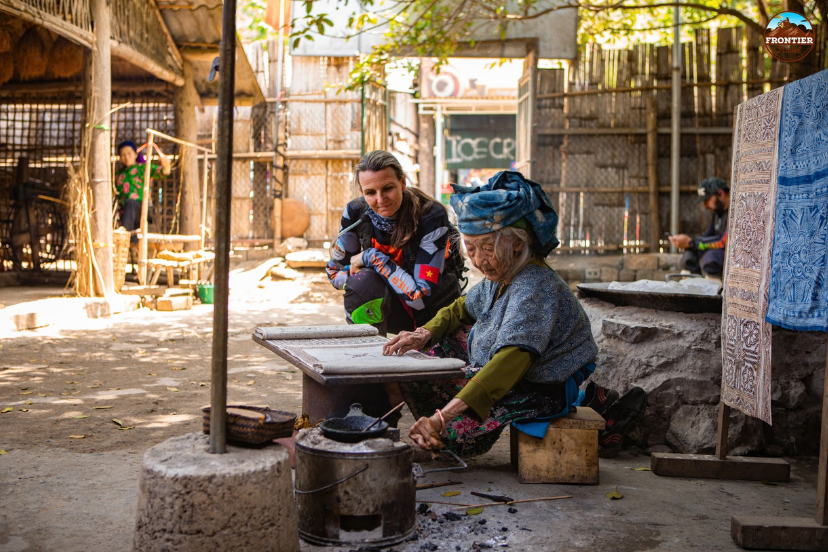 Tourists interacting with residents while joining their everyday cultural practices in a highland community.