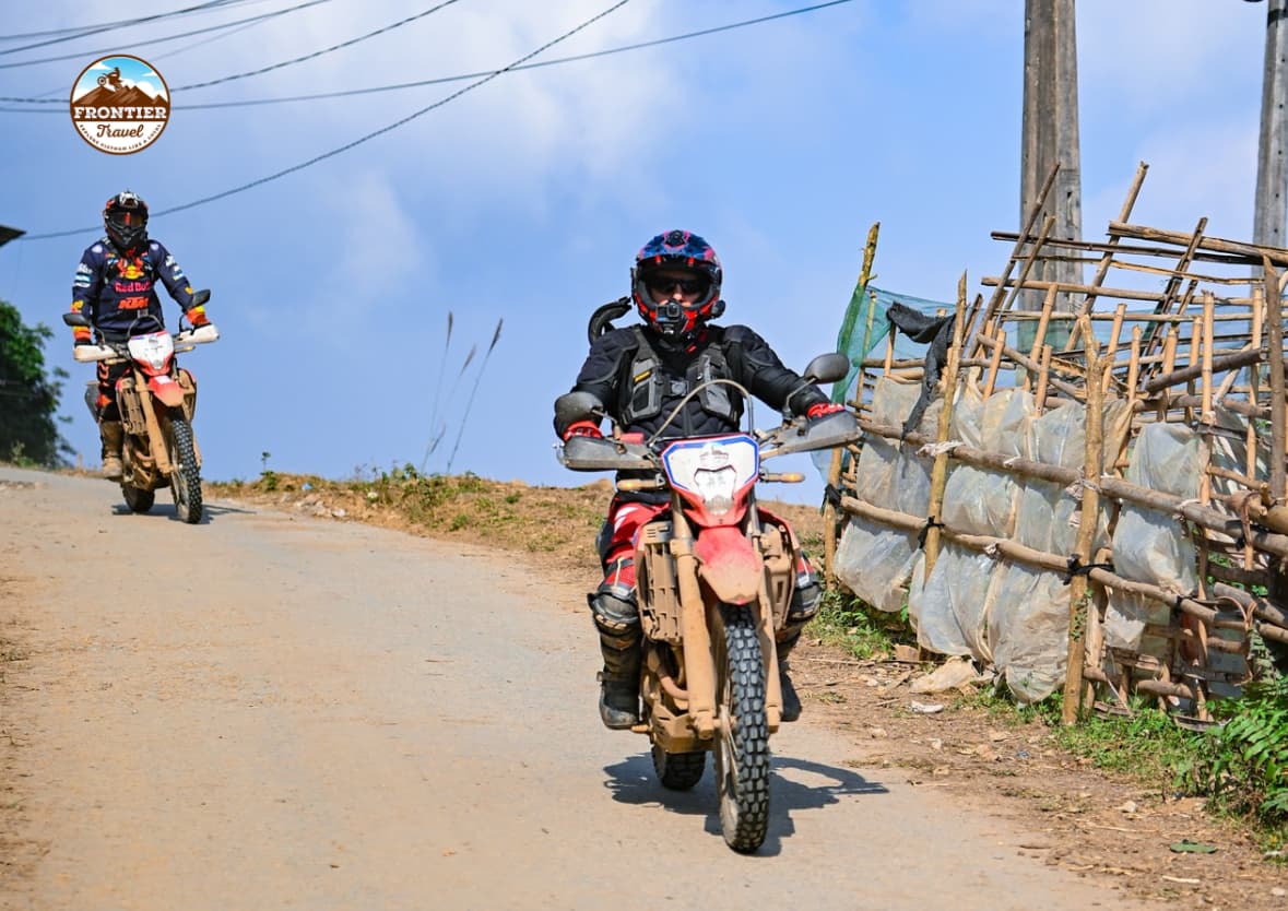 Motorbikes cruising through the golden rice fields of Mu Cang Chai in October, the most beautiful season for backpacking in Northern Vietnam.