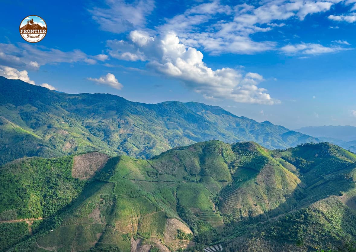 The majestic nature engulfs the small path, creating a breathtaking landscape in the vast wilderness.