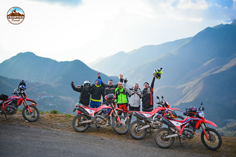 Motorcycle rider enjoying a remote mountain landscape in Vietnam after a challenging journey