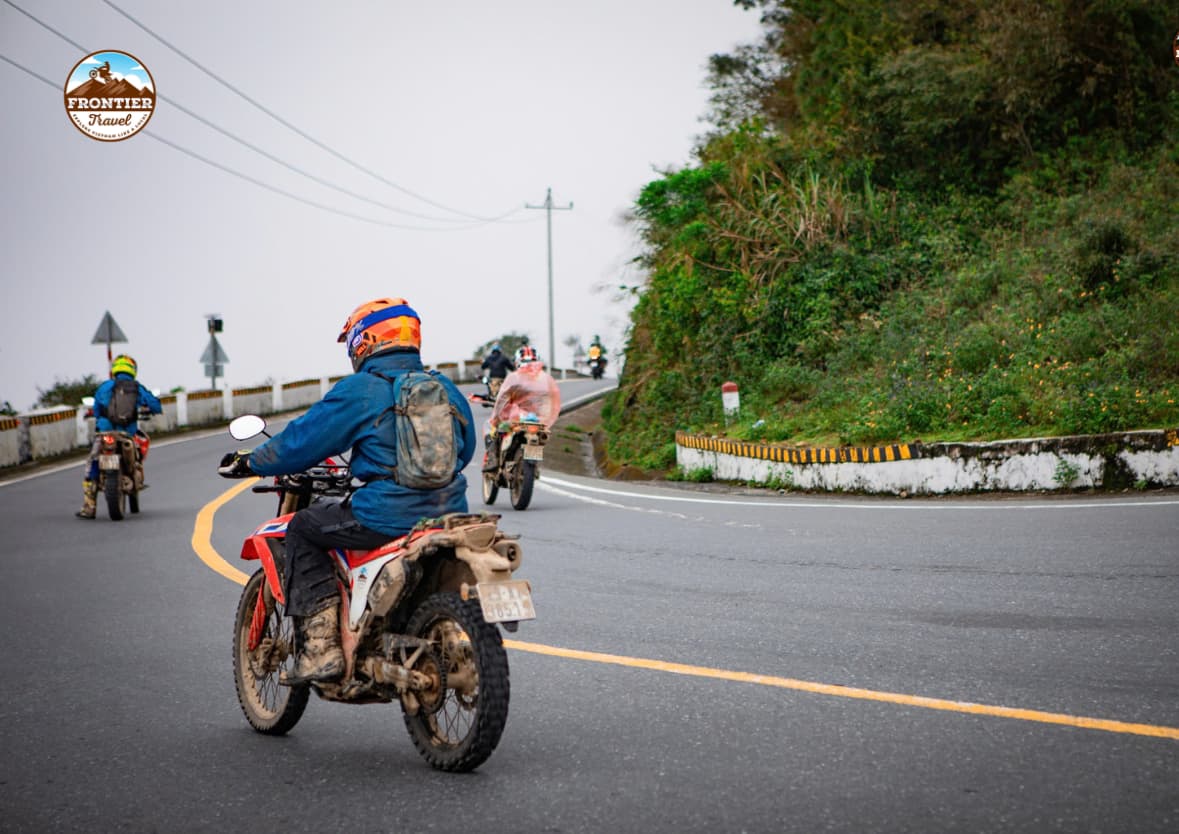 The biker's smooth cornering technique on a sport-touring motorcycle on the coastal mountain pass.