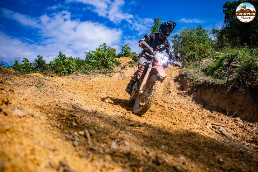 Motorbike rider descending a winding mountain pass