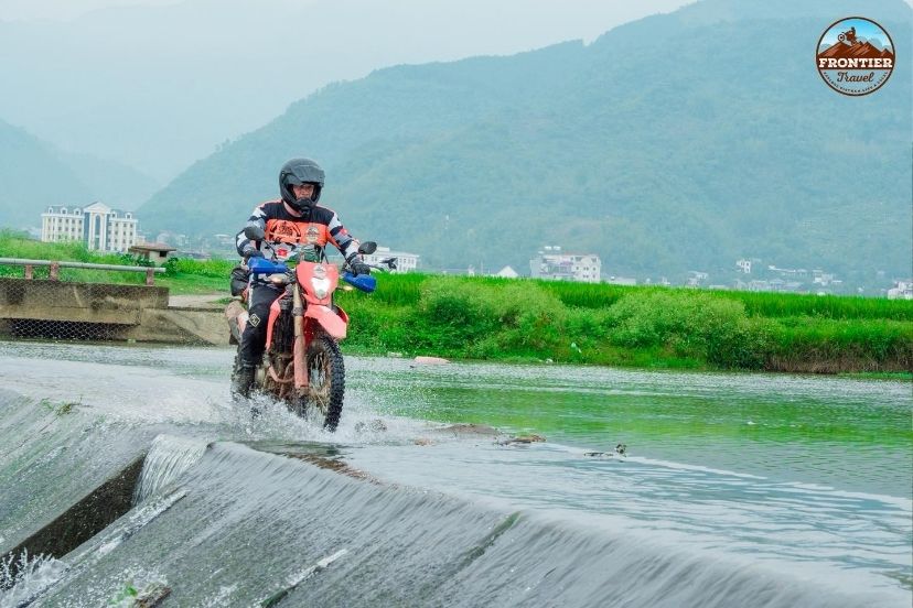 Bypassing the standard for unpaved wilderness tracks on a Hanoi to Saigon motorbike tour off-road.