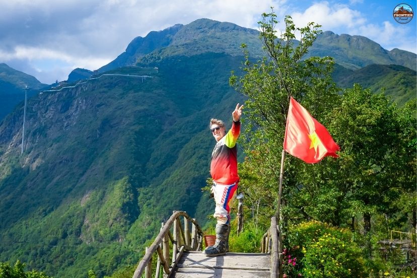 Conquering historic ridges on a Hanoi to Saigon motorbike tours adventure bike.