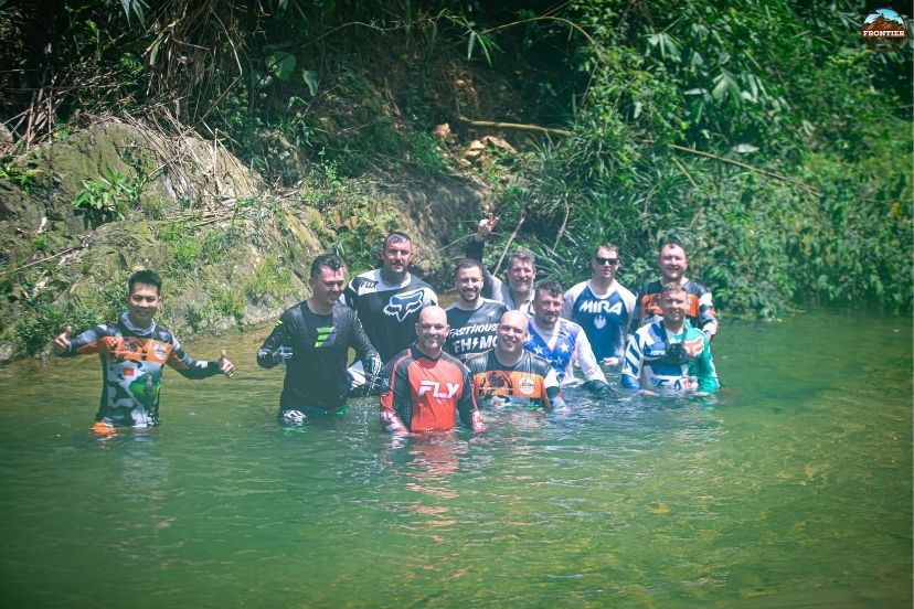 Steering through sticky mud trails on a Saigon to Hanoi motorbike tours off road trip.